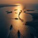 連川普都有稱讚的頑強伊朗人?戰爭消停機會渺茫。 2 Busy waterway at sunset with multiple ships, a jet plane, and one vessel emitting a large plume of black smoke
